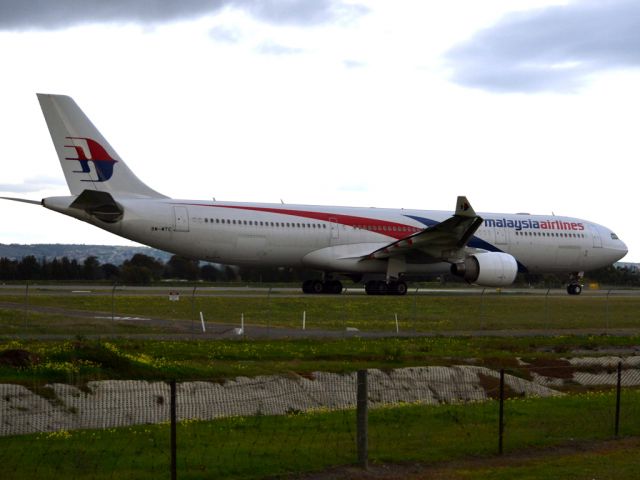 Airbus A330-300 (9M-MTC) - On taxi-way heading for take off on runway 05, for flight home to Kuala Lumpur, just before the arrival of a rain storm. Thursday 12th July 2012.