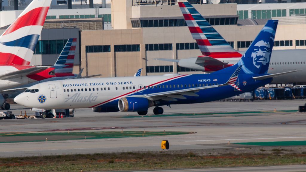 Boeing 737-800 (N570AS) - Painted in the Honoring Those Who Serve Livery. Tail tto the left is British Airways 777-300ER G-STBJ. Tail to the right is American Airlines 777-300ER N736AT.