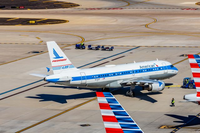 Airbus A319 (N744P) - An American Airlines A319 in Piedmont retro livery pushing back at PHX on 2/24/23. Taken with a Canon R7 and Canon EF 100-400 ii lens.