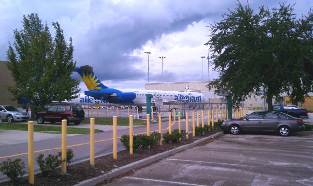 — — - Allegiant MD 90 resting at the Gate at Orlando Sandford Airport.