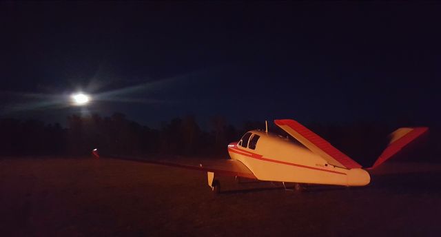 Beechcraft 35 Bonanza (N8799A) - Bonfire and moonlit Bonanza