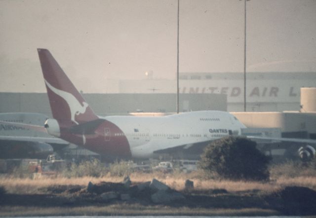 BOEING 747SP (VH-EAB) - KSFO - QANTAS Boeing 747SP at the old International terminal at San Francisco. I zoomed the color slide on the reg and it is EAB. The focus a bit off with a heavy 1000mm C-90 lens with XD-11 hand held from the dirt parking lots lots where Bayfront Park is now. date apprx mid to late 90s.