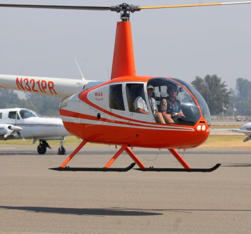 Robinson R-44 (N321PR) - KRDD - new helicopter landing at Air Shasta at Redding 9-2-2016. These 2 occupants did not know they were getting snapped until just about now! click full for full color!