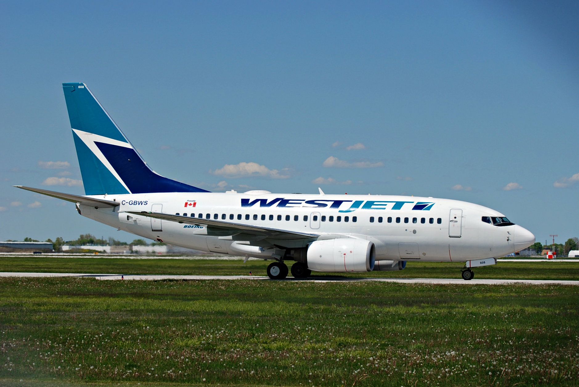 BOEING 737-600 (C-GBWS) - WestJet Boeing 737-600 taxiing into YQG from YYC.