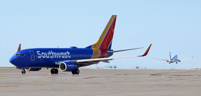 Boeing 737-700 (N7709A) - Flashback to Aug, 2019 ~~br /Seen here in Southwest paint, N7709A (previously Air Tran N176AT .... then after this photo United N24760) is taxiing out from the Buffalo Niagara International terminal as, in the distance, a United B739 begins to climb away from Runway 05.br /Only a few months after this photo was taken, N7709A went to United and was reregistered as N24760. However, its "career" as a United fleetbird was extremely short-lived; N24760 was stored by United less than one year after this pic was snapped (in June, 2020) due to the Covid outbreak and it remains WFU at this time (May, 2021). Although I was unable to definitively determine where it is right now, I suspect it is either already in, or is soon going to be in, the boneyard.