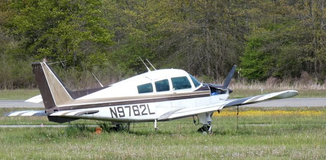 Beechcraft Sundowner (N9762L) - Amongst the weeds is this deregistered 1972 Hawker Beechcraft Musketeer C23 Sundowner in the Spring of 2023 with retractable landing gear should it be ever rescued.