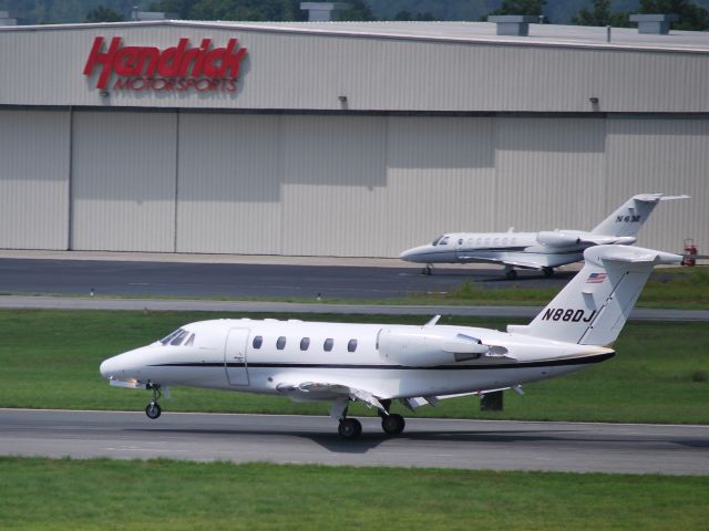 Cessna Citation III (N88DJ) - Arriving on runway 20 w/N6M parked in the background at the Hendrick Motorsports hangar - 7/28/09