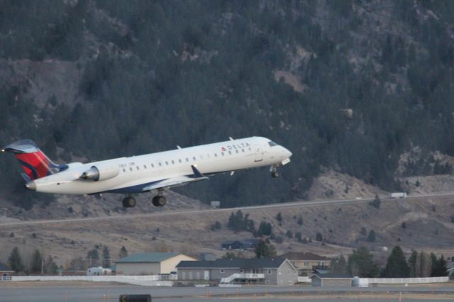 Canadair Regional Jet CRJ-700 (N713EV) - N713EV taking off runway 12 at Butte as SKYWEST 4312 to KSLC.br /br /Taken 18:09, November 2, 2024 with a Canon EOS T2i and 70-300mm (300mm, 1/250, ƒ5.6, ISO 3200)