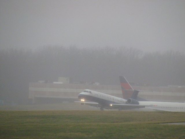 Embraer ERJ-145 (N812HK) - E145 "flaring" and touching down at CVG.br /br /Aircraft in the background is Delta Boeing 737-800 N3742C 