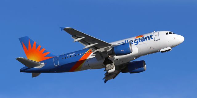 Airbus A319 (N319NV) - The wheels have been stowed away but the doors have not yet sealed the wells as AAY's N319NV climbs away from 16R to begin a midafternoon flight downstate to the former McCarran International (KLAS) in Las V.