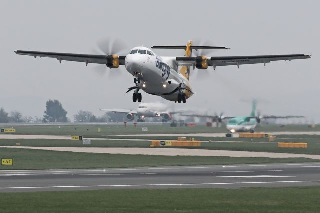 ATR ATR-72 (G-VZON) - AUR671 departing to Guernsey on a misty morning as SAS539 arrives from CPH in the background and EIN3721 make her way to 23L for departure.