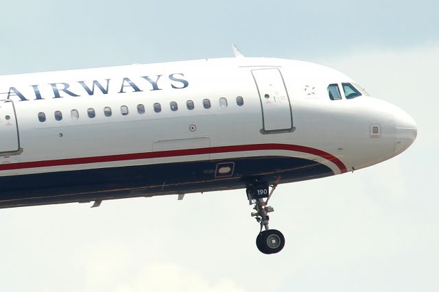 Airbus A321 (N190UW) - Cactus 951 on short final to RWY 18R from Washington DC. Taken from the FlightSafety International parking lot. I was spotting at MCO because my brothers missed their flight to MIA and got a flight to MCO instead.