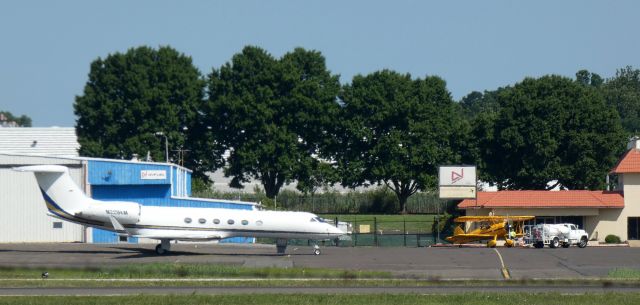 Gulfstream Aerospace Gulfstream V (N229KM) - Catching some tarmac time is this 1999 Gulfstream V while a 1942 Stearman fuels up from the Summer of 2022.