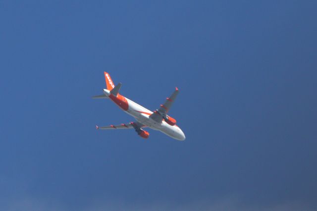 Airbus A320 (G-EZTR) - Easyjet A320 (G-EZRT) flies overhead.  April 2022