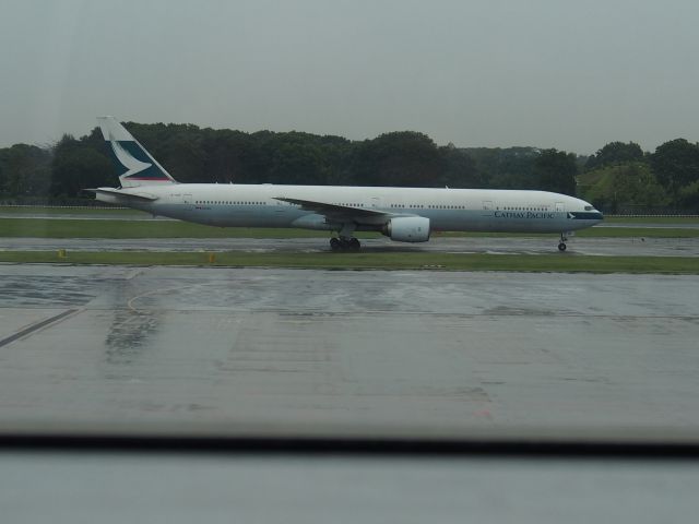 BOEING 777-300 (B-HNF) - Cathay Taxying past departure lounge.