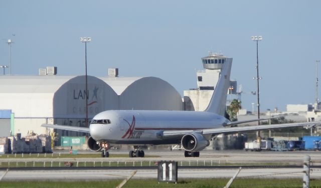 BOEING 767-300 (N363CM) - Notice the palletized cargo"To the left of the picture!"KMIA Is a major World cargo center!