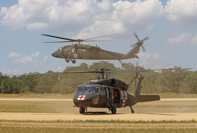 Sikorsky S-70 (9026307) - US Army National Guard UH-60A Blackhawk 90-26307 kicking up the grass & dust on approach behind 82-23698 at Fort McCoy/Young Air Assault Strip (WS20) on 17 Jul 2013.