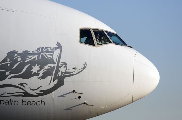 Boeing 777-200 (VH-VOZ) - Smile, you made it to Los Angeles! This crew has just landed their Boeing 777 at sunrise at LAX and are taxiing to their gate at the Bradley International Terminal.