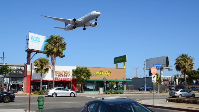 Boeing 787-9 Dreamliner (N27964) - A 787 flying over a marijuana delivery billboard... The future is NOW!