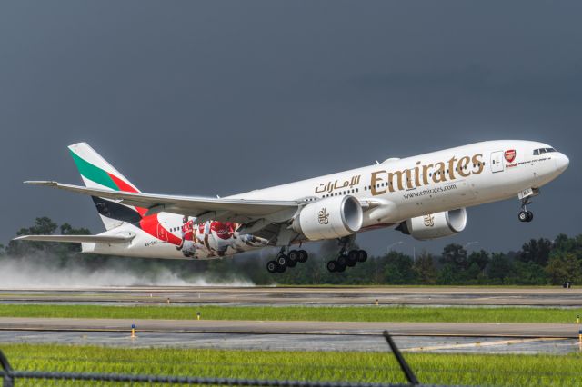 Boeing 777-200 (A6-EWJ) - Emeriates 220 Heavy departing runway 17R after nasty thunderstorm over central Florida on its way back to Dubai. (Arsenal Special Livery) (9/5/15)