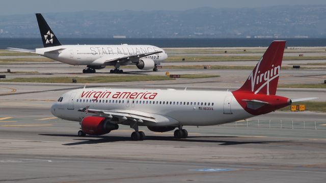 Airbus A320 (N836VA) - Spruce Moose - Also N218UA (B772) in the background taxiing out for departure.