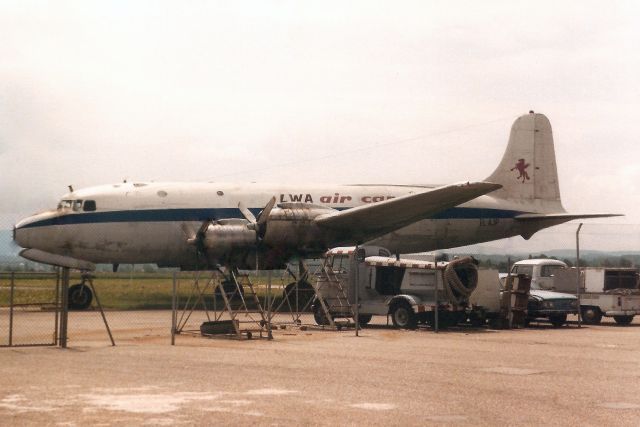 Douglas C-54 Skymaster (EL-AJP) - Seen here in Aug-89.br /br /With Liberia World Airlines from Dec-87 to Sep-89 when it reverted to N88887 and was put on display at the Luftbrückendenkmal at EDDF.  Registration cancelled 17-Jan-90.