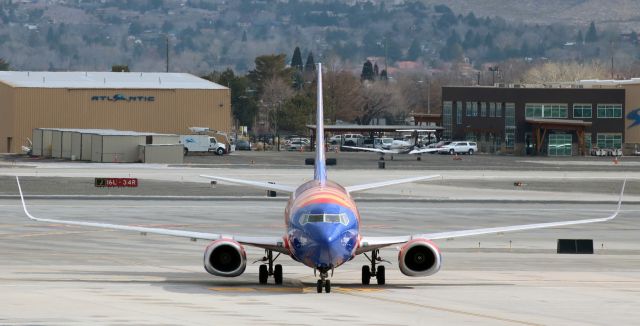 BOEING 737-300 (N383SW) - N383SW, the first Southwest fleetbird to wear the "Arizona One" livery, clicked last year as it was turning from Alpha taxiway on to the SW deck at RNOs Concourse B.