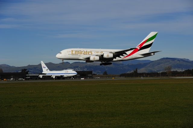 Airbus A380-800 (A6-EET) - Probably a "once only" capture of the "daily whale flight arrival" into Christchurch with such a gorgeous aircraft waiting in the background!br /On 20 July, SOFIA (N747NA), our part time resident B74S, was scheduled to depart and fly back to Palmdale AFB via Hawaii, but was a little early at the holding point, so had to give way to the landing A380. And I was ready up the ladder to see over the fence and capture the beaut "8 engine meet".br /I understand that Christchurch is the smallest international airport to serve the A380, and we get one daily. So, for a small country and small airport, we certainly get some unique "Heavies" and "Supers-Heavies" quite regularly.