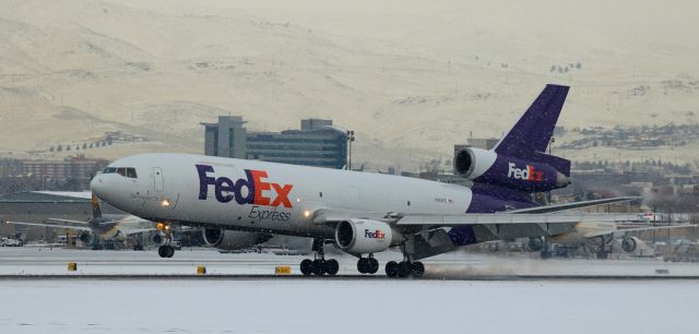 McDonnell Douglas DC-10 (N313FE) - It has been a long time since the opportunity to snap some inclement weather photos has presented itself, but the past weeks WX (7 to 9 feet of snow and then several inches of rain that melted it all and created extreme flooding) provided all sorts of snowstorm and poor weather scenes at RTIA.  In this snap, taken as the first of the areas snow was falling, Fed Exs "Bilal" (N313FE) arrives from Oakland and, under gray skies, touches down on Reno Tahoe Internationals runway 16R just after 8 AM.br /As always, I recommend the actual size photo (FULL) for best Q viewing.