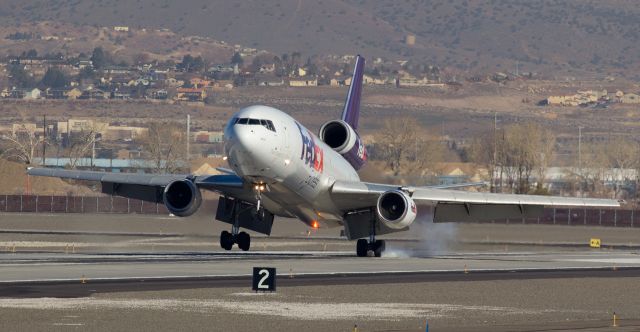 McDonnell Douglas DC-10 (N68049) - Departing KMEM about four hours late yesterday meant that FDXs "Dusty" (N68049) arrived here in balmy Reno at midmorning.  While a large part of the US was either buried deep under snow, frozen solid under ice, or both, I was wearing a short sleeve shirt in the sun in 70 degree temperatures while standing about 2/3rds of the way down runway 16L to capture this long-range shot of Dustys left mains making first contact with the concrete.  I cant get cool shots of aircraft landing or taxiing in frigid surroundings like some of FAs east coast photogs are snapping right now, but Ill be honest ... after seeing what yall are dealing with there, Im OK with being right here and clicking pics like this one.