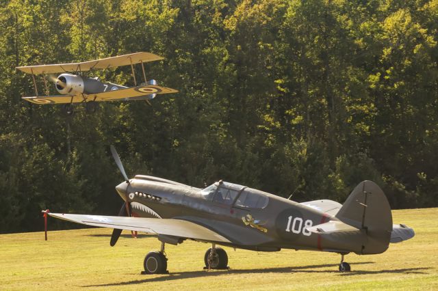 CURTISS Warhawk (N1941P) - N4088H Sopwith 1 1/2 Strutter Replica departs, N1941P Curtis Wright P40E foreground at the Military Aviation Museum, Virginia Beach Airport. October 2021.