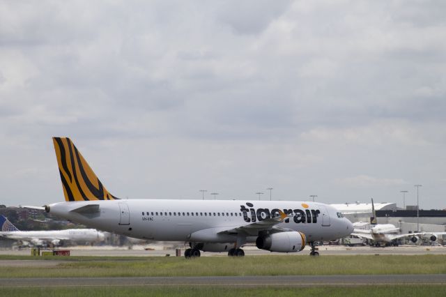 Airbus A320 (VH-VNC) - Under the Control Tower.