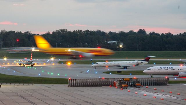 Canadair Regional Jet CRJ-900 (N912XJ) - Here is a cluster of aircraft awaiting departure including a DHL 777-F, American E170, Endeavor CRJ-900, and a United 737-900.