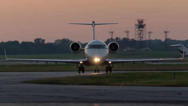 Canadair Regional Jet CRJ-200 (N8884E) - A CRJ-200 taxis toward the gates as the last bit of light fades away.