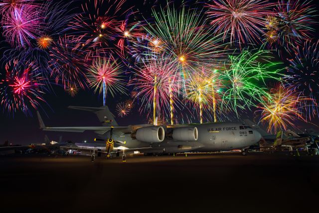 Boeing Globemaster III — - This photo was taken at the 2022 Sun N Fun Airshow in Lakeland Florida. The fireworks show concluded the amazing nighttime airshow. The primary (or actually the largest) aircraft in this photo is a C-17 Globemaster out of Charlotte North Carolina. The Other is the "Little Witch" P-51 Mustang Tail number N51LW. I shot this with my Canon 5Dsr and my Canon 17-40 F4 lens. Please check out my other aviation photography.  Votes and positive comments are always appreciated. Questions about this photo can be sent to Info@FlewShots.com