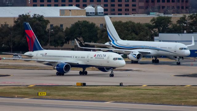 Boeing 757-200 (N650DL) - A Charter Delta 757-200 taxiing past N801DM, a privately owned B752 at Love Field.