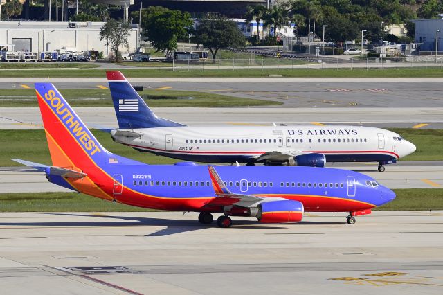 Boeing 737-700 (N932SW) - SWA and US Airways taxi for takeoff at KFLL