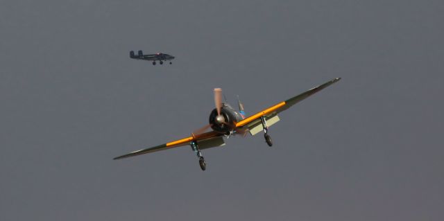 Mitsubishi A6M Zero (N712Z) - With the dark clouds of a very brief snow squall over the Sierra Nevada as a backdrop, two Commemorative Air Force aircraft, a replica Mitsubishi Zero (N712Z) and a B-25J Mitchell, arrive at the 2019 National Championship Air Races (aka: Reno Air Races) last night shortly after 6 PM. 