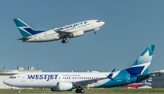 Boeing 737 MAX 8 (C-FNWD) - Old and new in most regards... C-FNWD taxis to runway 05 for departure to Calgary as WJA655. In the background WJA163 gets underway bound for Winnipeg