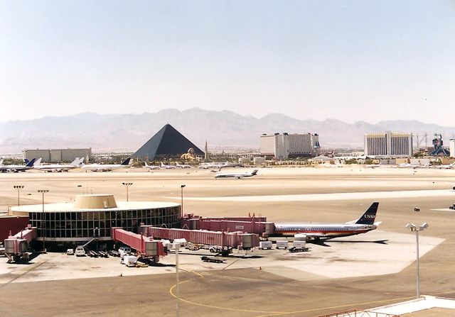 BOEING 737-400 — - KLAS US Air now US Airways 737 400 at the gate at Las Vegas NV it was 118 degrees when I took this from the parking lot. The skyline is waaaaaaaaaaaaaay different now for LAS. July 1995 photo.