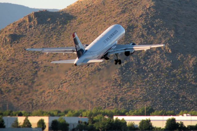 Airbus A319 (N813AW) - With Rattlesnake Mountain in the background, this first photo of N813AW in the FA photo gallery shows AWEs first Reno departure of the morning, Cactus 158, climbing away from RTIAs runway 16R enroute to KPHX.