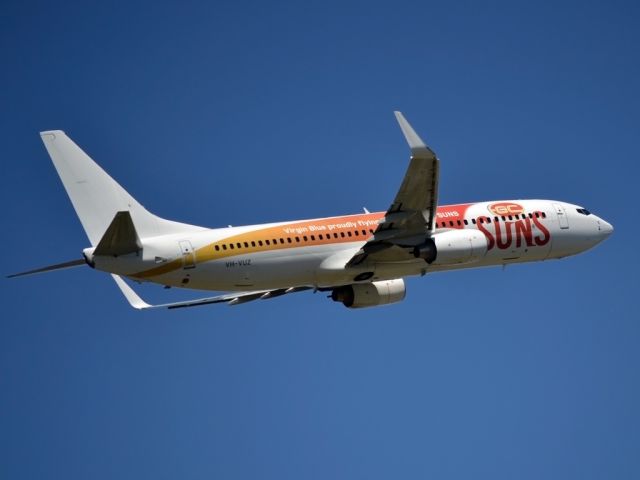 Boeing 737-800 (VH-VUZ) - Special livery displaying Virgin Blues sponsorship of the Gold Coast Suns Football Club. Most appropriate for this flight as this bird was heading for the tropical sunshine of Bali.