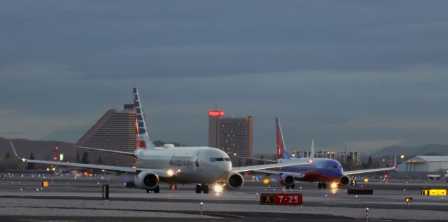 Boeing 737-800 (N848NN) - "Gentlemen, On Your Mark, Get Set, GO!"br /In this dawn-light photo of a "Boeing 738 Jet Class" "race," (obviously, I'm j/k -- grin) the 6 AM race is in progress as American's N848NN, southbound on Taxiway Alpha, is in the lead versus Southwest's N8631A, southbound on Taxiway Bravo. The AAL B738 is just about to cross the "finish line" (the centerline of Runway 7-25); however, despite being the "winner,' once the two 738s got to the ends of their respective taxiways, the American jet had to wait so that the Southwest flight could depart on 34L first.  ..  0/103/@6