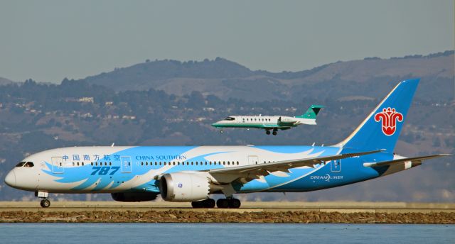 Boeing 787-8 (B-2737) - A Learjet 45(C-FBCL) landing over the China Southern Dreamliner, as it departs