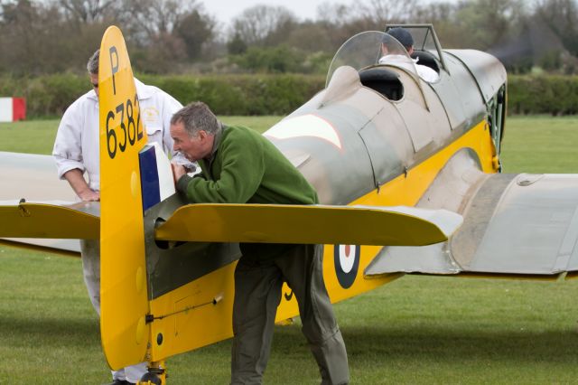 — — - Engine run up. Note the Pilots pants/trousers receiving the full blast from the prop wash.