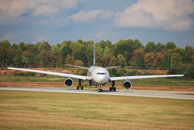 Airbus A330-300 (N272AY) - Taxiing into position 18C - 10/20/10