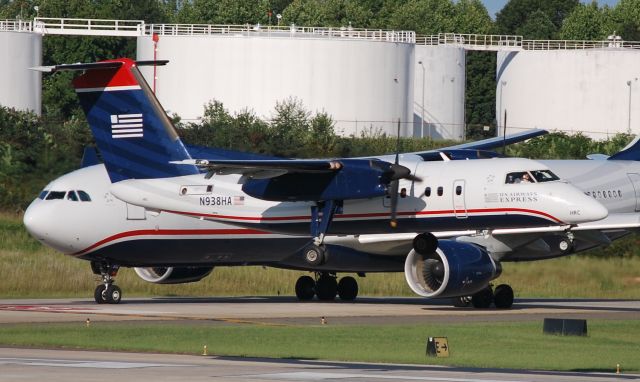 de Havilland Dash 8-100 (N938HA) - Arriving runway 18C with A333 holding in the background - 9/27/09