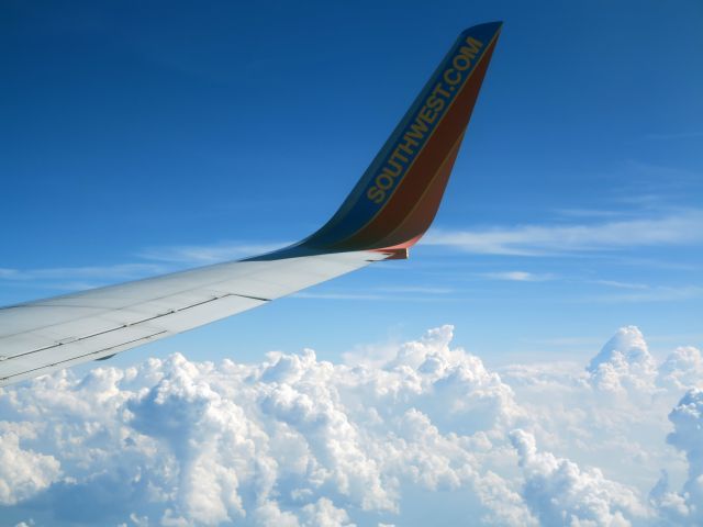 Boeing 737-700 (SO-UTH) - At FL390 above convective clouds.
