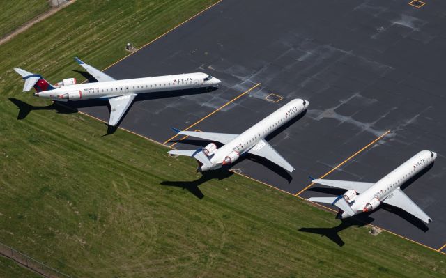 Canadair Regional Jet CRJ-900 (N304PQ) - N304PQ, N927XJ, and N367CA sit grounded on the ramp due to COVID-19.