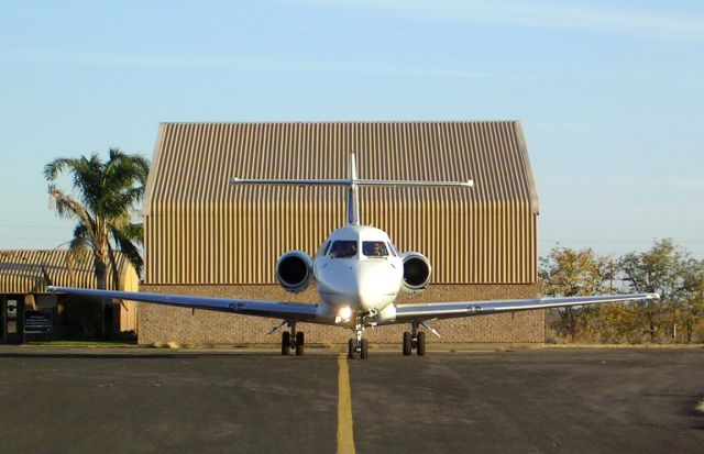 ZS-PLC — - Zenith Airs Hawker at the Venetia Mine airport (FAVM). Note the drive thru hangar in the background.